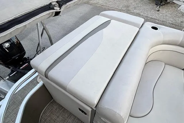 Slide: The Image of 2015 Bennington 24 SLX boat interior with cushioned seating and cup holder. - 9
