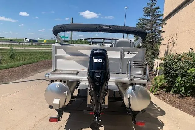 Slide: The Image of 2026 Sun Tracker Party Barge 16 DLX pontoon boat with 50 HP motor, parked outdoors. - 22