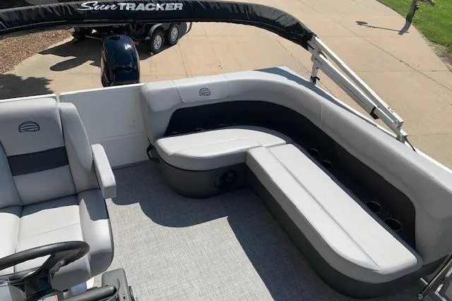 Slide: The Image of 2026 Sun Tracker Party Barge 16 DLX interior with plush seating and modern design. - 26