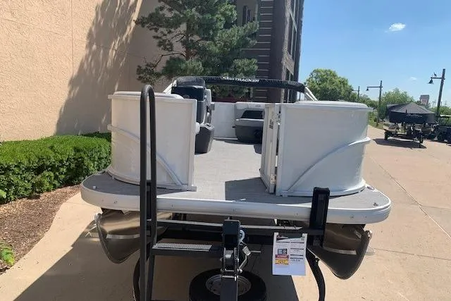 Slide: The Image of 2026 Sun Tracker Party Barge 16 DLX pontoon boat on trailer, parked outdoors. - 21