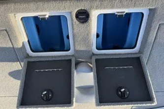 Slide: The Image of 2026 Nitro Z21 XL Pro boat storage compartments with open lids and secure locks. - 11