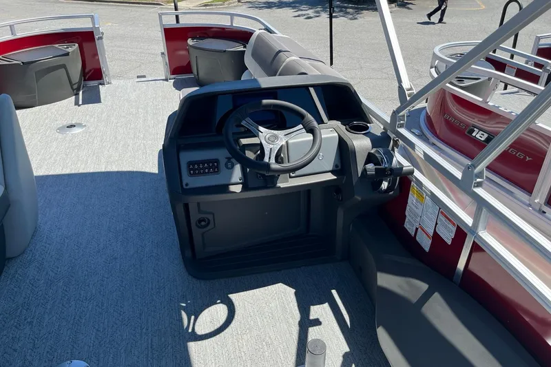 Slide: The Image of 2026 Sun Tracker Fishin' Barge 22 DLX pontoon boat interior with steering console. - 4