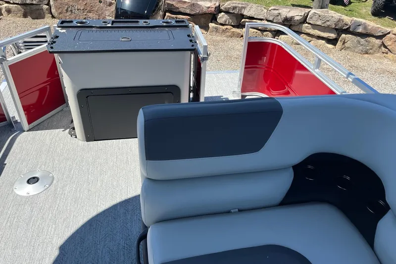 Slide: The Image of 2026 Sun Tracker Fishin' Barge 22 DLX interior with seating and storage area. - 5