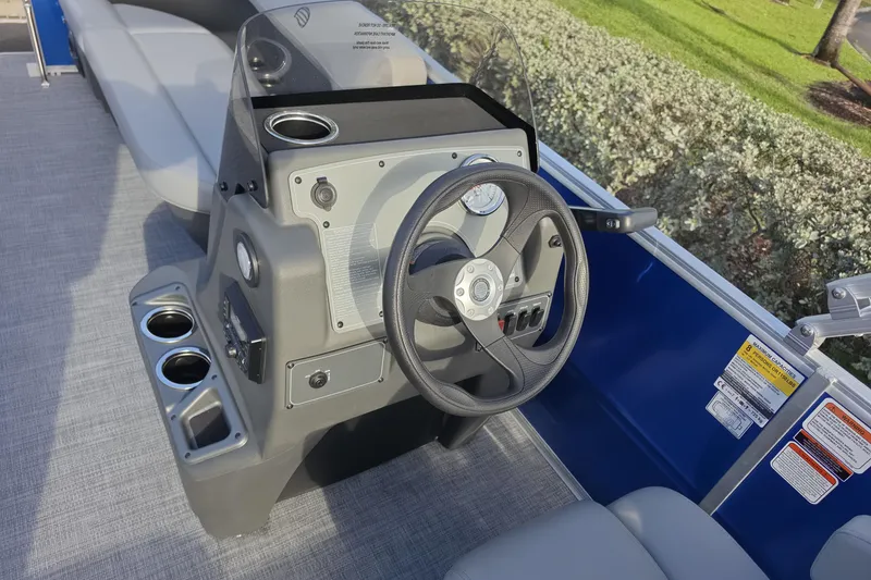 Slide: The Image of Steering console of 2026 Sun Tracker Party Barge 16 DLX pontoon boat with cup holders. - 2