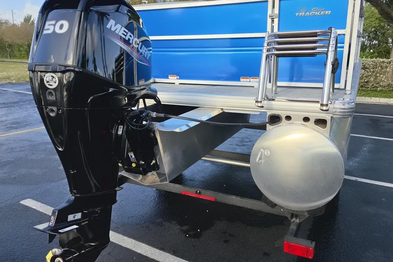 Slide: The Image of 2026 Sun Tracker Party Barge 16 DLX with Mercury 50 outboard motor in parking lot. - 7