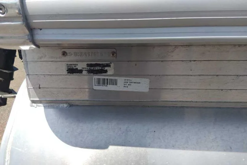Slide: The Image of 2026 Sun Tracker Party Barge 16 DLX identification plate on aluminum surface. - 10