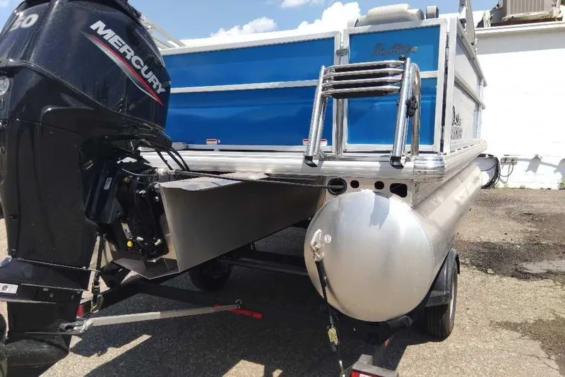 Slide: The Image of 2026 Sun Tracker Party Barge 16 DLX with Mercury outboard motor, rear view. - 8