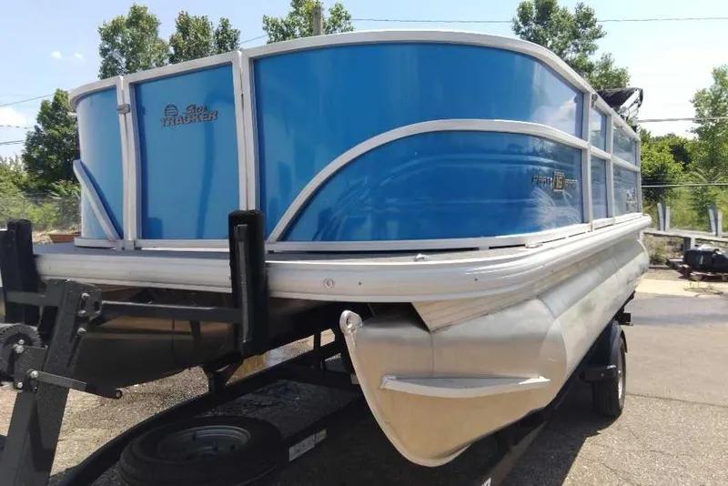 Slide: The Image of 2026 Sun Tracker Party Barge 16 DLX pontoon boat on trailer, blue exterior. - 3