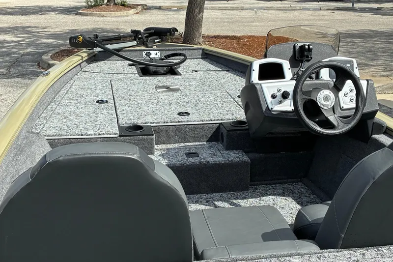 Slide: The Image of 2026 Tracker Pro Team 175 boat interior with steering console and seating. - 2