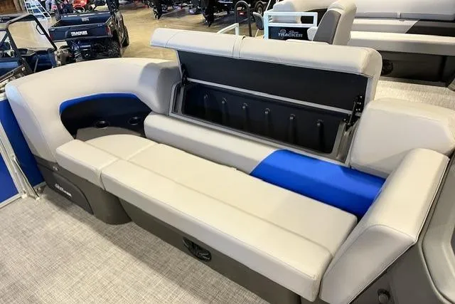Slide: The Image of 2026 Sun Tracker Party Barge 20 DLX interior seating with storage compartment open. - 82