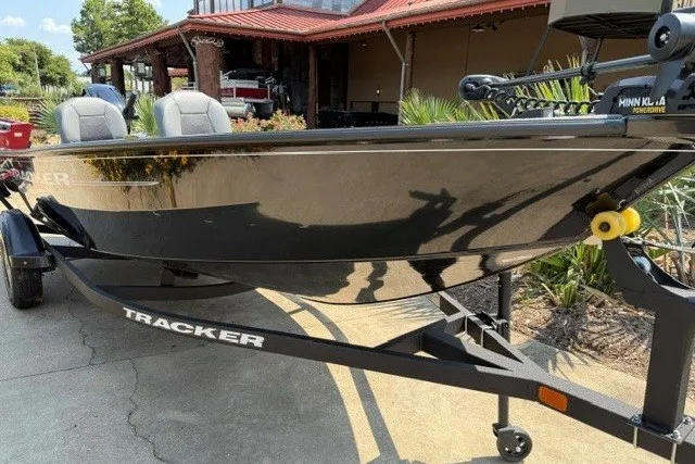 The Image of 2025 Tracker Super Guide V-16 T boat on trailer, parked outdoors. - 0