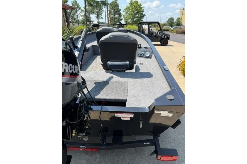 Slide: The Image of 2025 Tracker Super Guide V-16 T boat with Mercury engine, parked outdoors. - 5