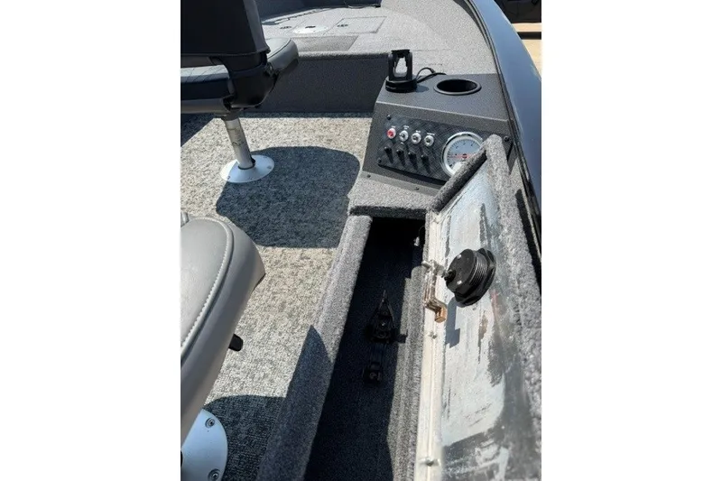 Slide: The Image of Interior view of 2025 Tracker Super Guide V-16 T boat, featuring seating and control panel. - 7