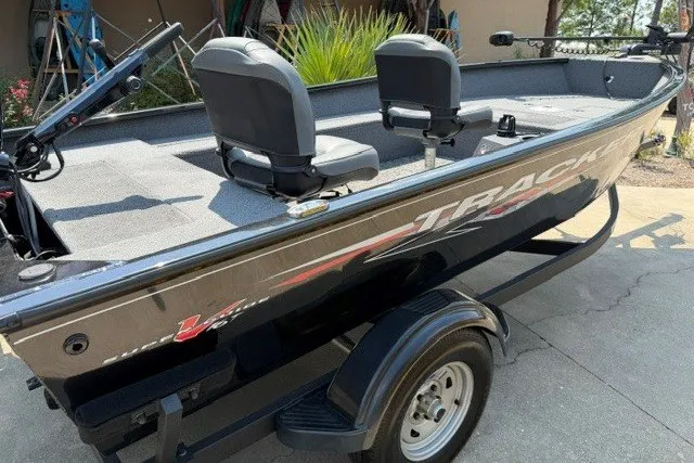 Slide: The Image of 2025 Tracker Super Guide V-16 T fishing boat with dual seats and sleek design. - 3