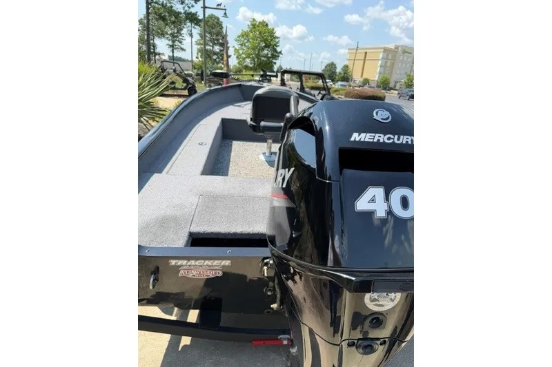 Slide: The Image of 2025 Tracker Super Guide V-16 T boat with Mercury 40 engine, parked outdoors. - 4