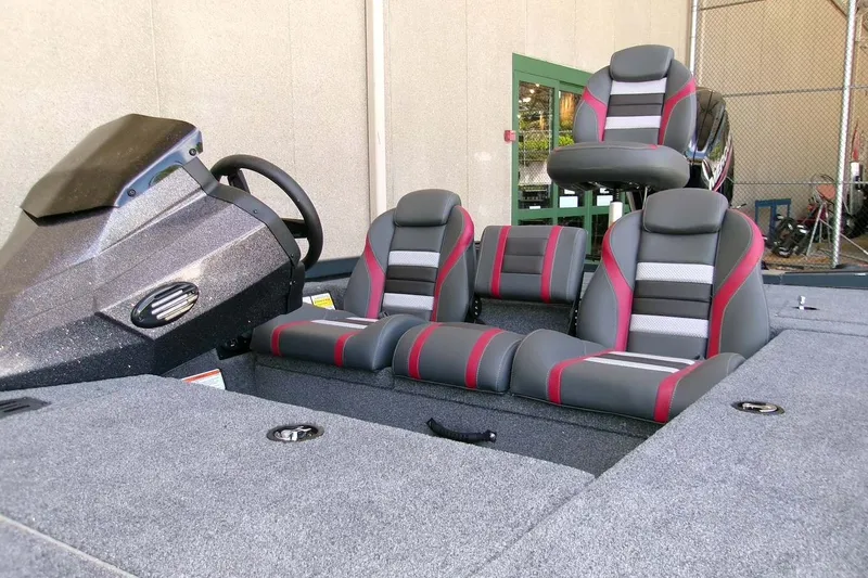 Slide: The Image of 2026 Ranger RT178C boat interior with gray and red seating, steering console, and carpeted deck. - 4