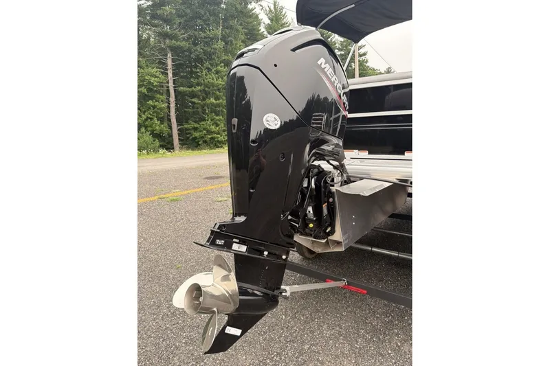 Slide: The Image of 2026 Sun Tracker Party Barge 20 DLX with Mercury outboard motor on a trailer. - 13