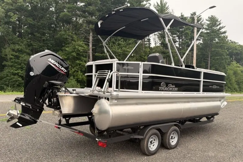 Slide: The Image of 2026 Sun Tracker Party Barge 20 DLX pontoon boat with Mercury engine on trailer. - 5