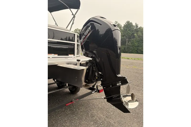 Slide: The Image of 2026 Sun Tracker Party Barge 20 DLX with Mercury outboard motor, parked on asphalt. - 12
