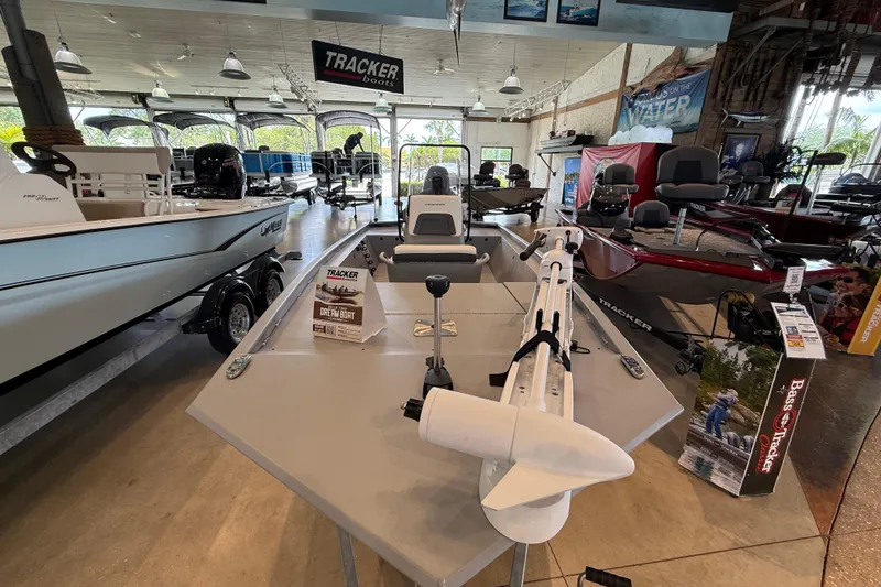 The Image of 2026 Tracker Bass Tracker Classic CC boat displayed in a showroom with other models. - 0
