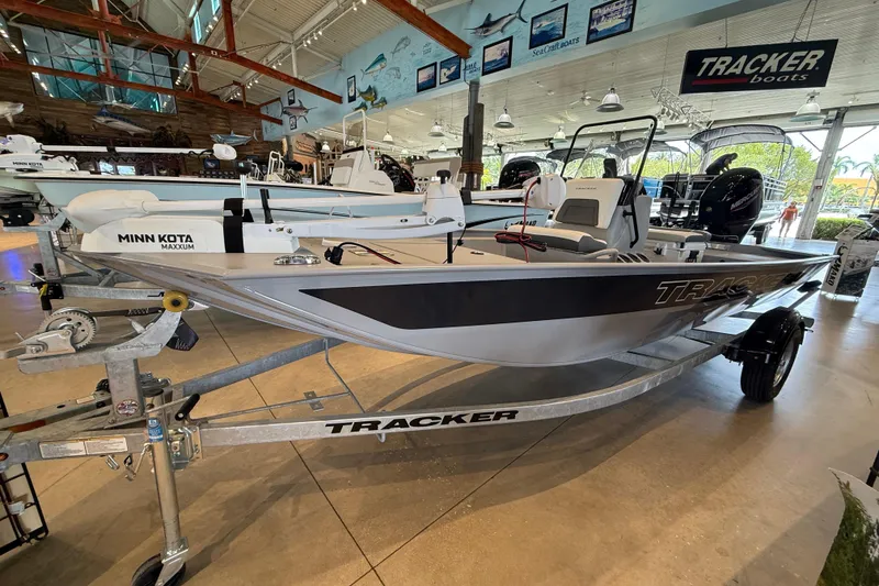 Slide: The Image of 2026 Tracker Bass Tracker Classic CC boat displayed in showroom on trailer. - 2