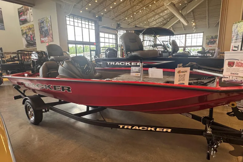 Slide: The Image of 2026 Tracker Pro Team 175 boat displayed in a showroom, featuring a sleek red design. - 50