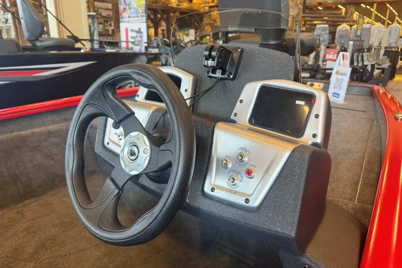 Slide: The Image of 2026 Tracker Pro Team 175 boat dashboard with steering wheel and control panel. - 51