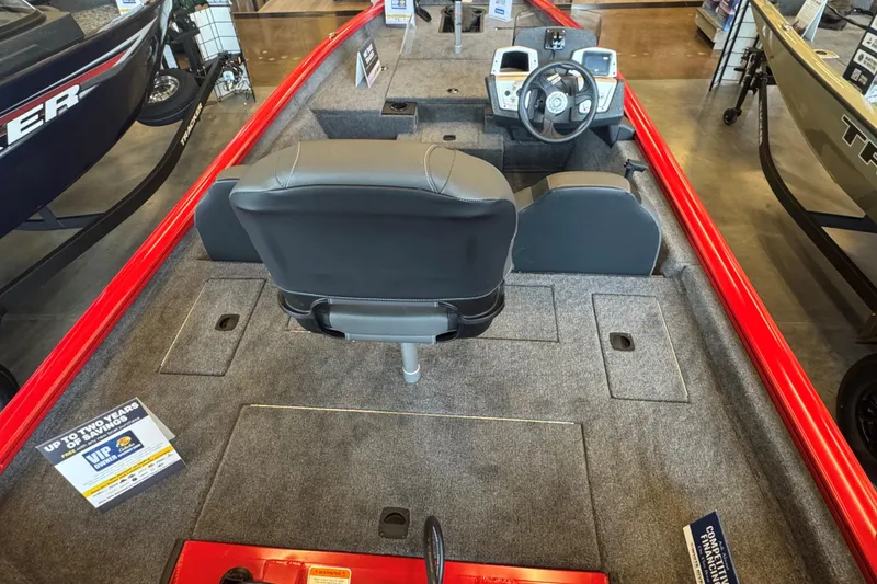 Slide: The Image of 2026 Tracker Pro Team 175 boat interior with steering wheel and seating, displayed in showroom. - 52