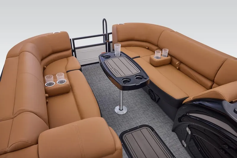 Slide: The Image of Luxurious seating area on 2026 Regency 230 DL boat with cup holders and table. - 19