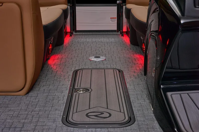 Slide: The Image of Interior of 2026 Regency 230 DL boat with red ambient lighting and sleek flooring. - 26
