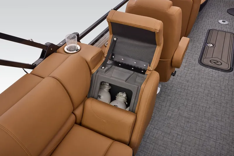 Slide: The Image of Luxurious seating with storage on 2026 Regency 230 DL boat, featuring tan upholstery and cup holder. - 40