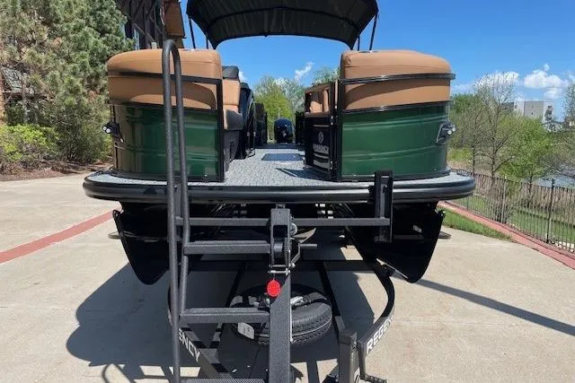 Slide: The Image of 2026 Regency 230 DL pontoon boat on trailer, parked outdoors on a sunny day. - 5
