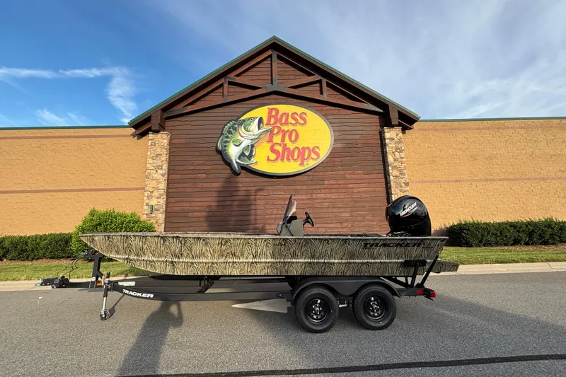 The Image of 2026 Tracker Grizzly 2072 CC boat on trailer outside Bass Pro Shops. - 0