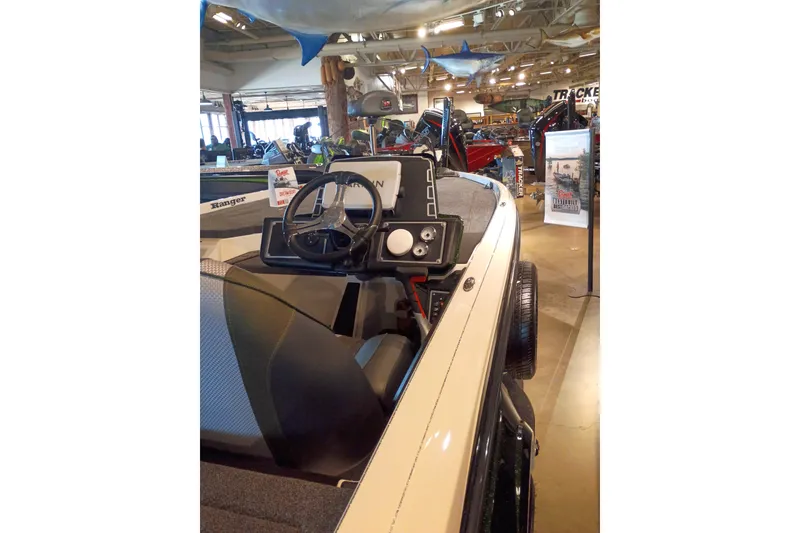 Slide: The Image of 2026 Ranger Z520 boat interior with steering wheel, displayed in a showroom setting. - 3