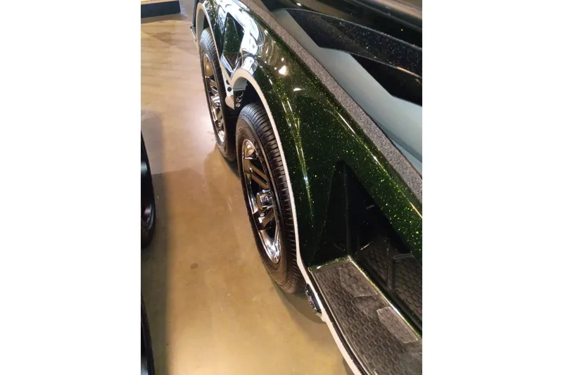 Slide: The Image of 2026 Ranger Z520 trailer with shiny green metallic finish and chrome wheels. - 6