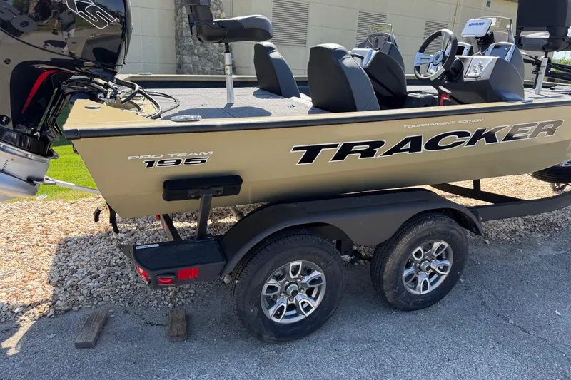 The Image of 2026 Tracker Pro Team 195 boat on trailer, featuring dual seats and outboard motor. - 0