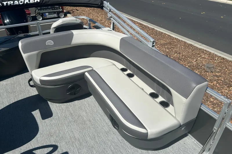 Slide: The Image of 2026 Sun Tracker Bass Buggy 18 DLX pontoon boat seating with cup holders and sleek design. - 21