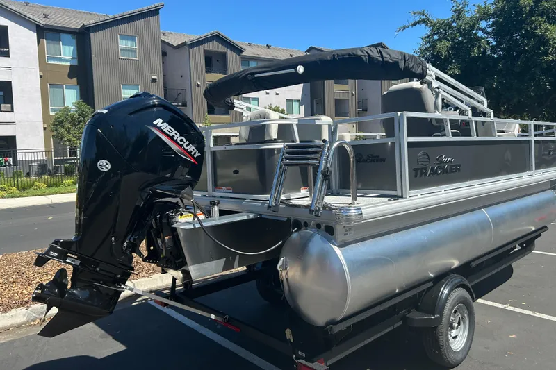 Slide: The Image of 2026 Sun Tracker Bass Buggy 18 DLX pontoon boat with Mercury outboard motor. - 3