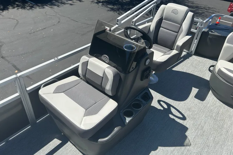 Slide: The Image of 2026 Sun Tracker Bass Buggy 18 DLX pontoon boat interior with steering console and seating. - 14