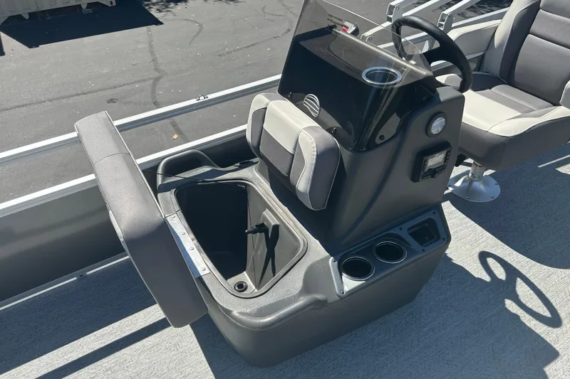 Slide: The Image of 2026 Sun Tracker Bass Buggy 18 DLX boat interior with storage compartment and seating. - 16