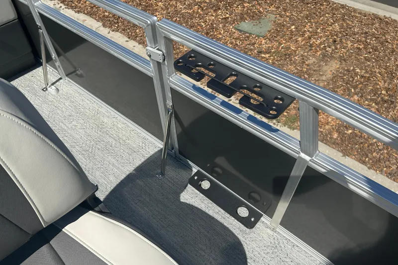 Slide: The Image of Interior view of 2026 Sun Tracker Bass Buggy 18 DLX pontoon boat with seating and railing. - 12