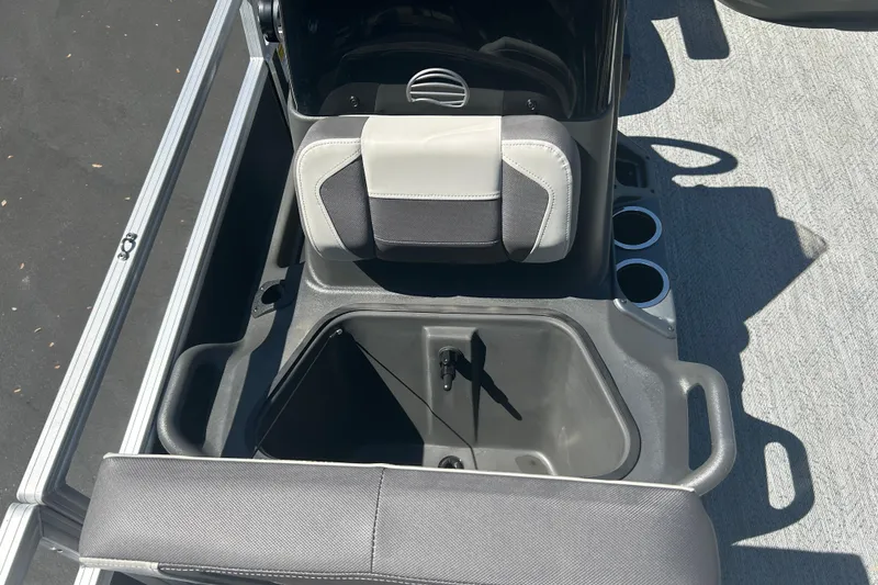 Slide: The Image of 2026 Sun Tracker Bass Buggy 18 DLX boat interior with storage compartment and cup holders. - 17