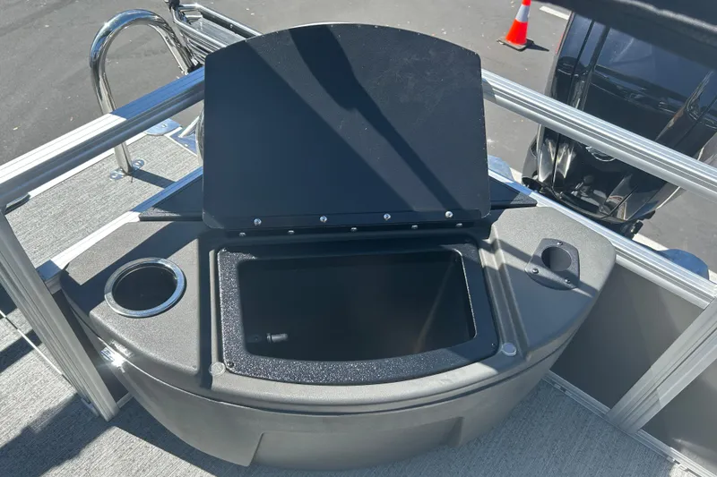 Slide: The Image of 2026 Sun Tracker Bass Buggy 18 DLX boat with open storage compartment and cup holder. - 25
