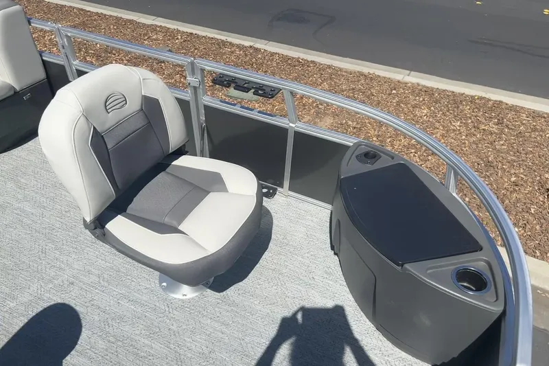 Slide: The Image of 2026 Sun Tracker Bass Buggy 18 DLX pontoon boat interior with seating and storage. - 5