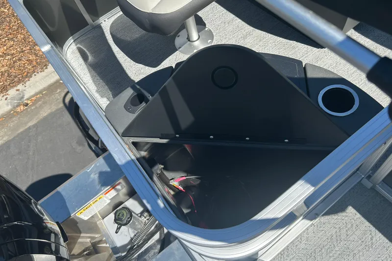 Slide: The Image of 2026 Sun Tracker Bass Buggy 18 DLX interior storage compartment with cup holder and seat. - 26
