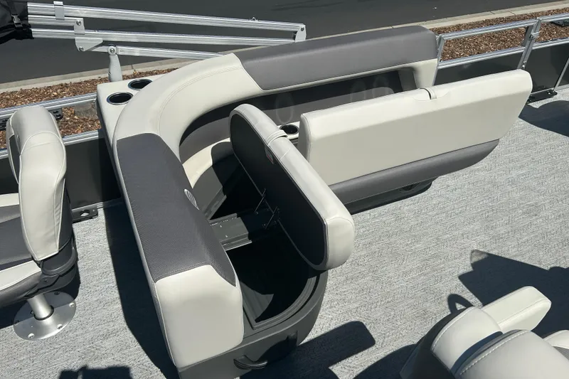 Slide: The Image of 2026 Sun Tracker Bass Buggy 18 DLX pontoon boat interior with seating and cup holders. - 23