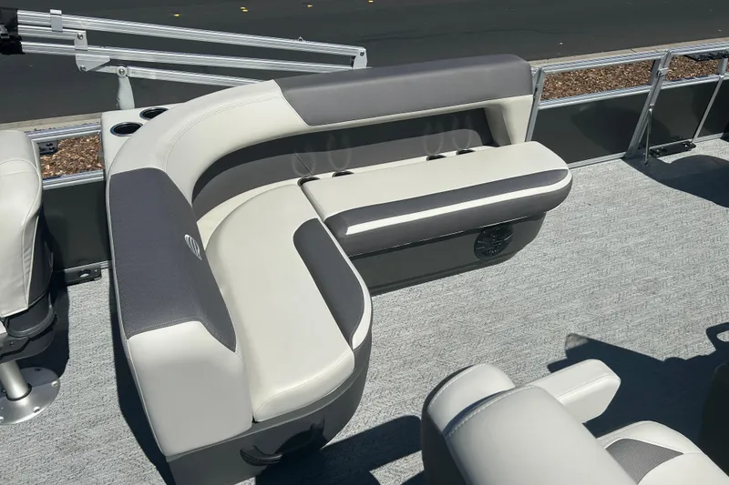 Slide: The Image of 2026 Sun Tracker Bass Buggy 18 DLX pontoon boat interior with gray and white seating. - 20