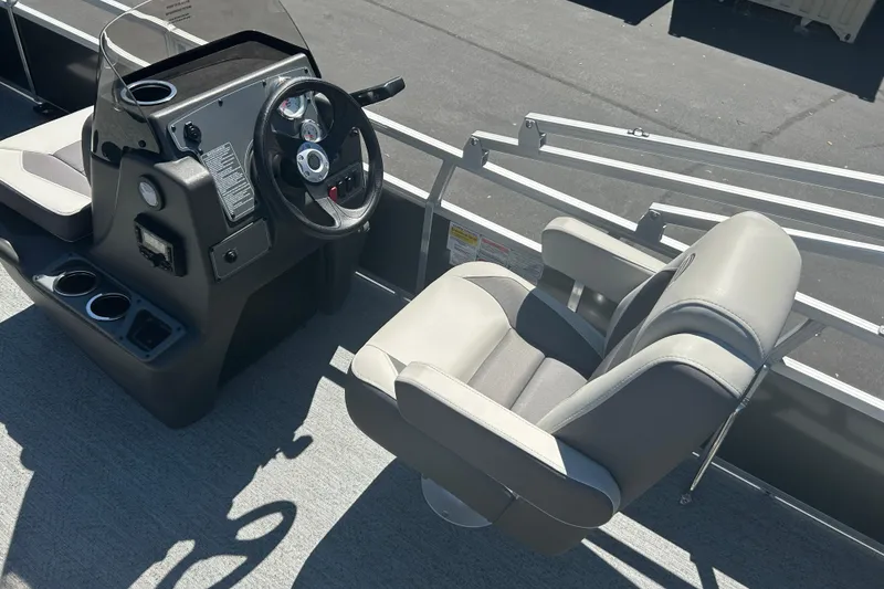 Slide: The Image of 2026 Sun Tracker Bass Buggy 18 DLX boat interior with steering console and captain's chair. - 18