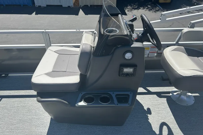 Slide: The Image of 2026 Sun Tracker Bass Buggy 18 DLX boat interior with steering console and seating. - 15