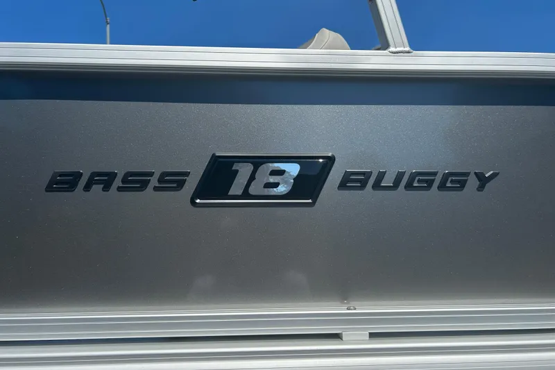 Slide: The Image of 2026 Sun Tracker Bass Buggy 18 DLX logo on metallic surface. - 32